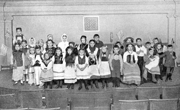 Children of Many Nationalities at Christmas
Celebration in a New York School.
Chinese, Italians, Swedes, Irish, English, German, French, Russian,
Austrian.